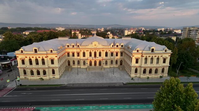 Aerial drone pan of the Bacău Prefecture, also known as the Administrative Palace &mdash; a grand neoclassical government building in Romania under a dramatic evening sky.