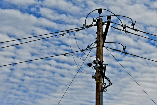 Retrofitted power pole with new jumper cables, cutout fuses and guy wires 