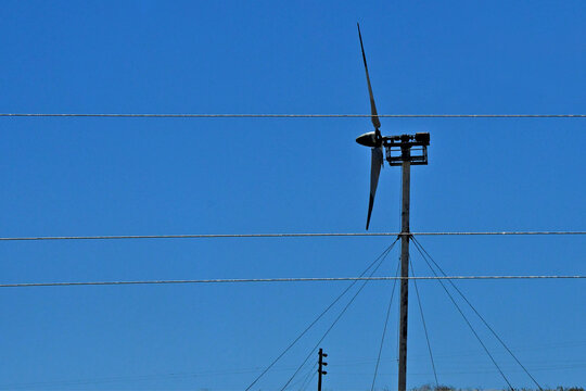 Old style wind turbine with faring off showing a simple propeller and generator, Altamont Pass, Alameda County, California 