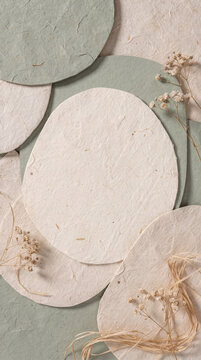 Sage green and cream handmade paper layers with dried gypsophila flowers and natural raffia
