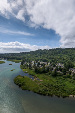 Aerial View of Riverfront Town and Forested Hills in Fraser Valley, Mission, British Columbia, Canada