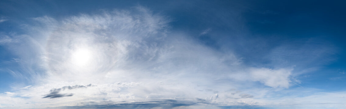 Dramatic Sunny Sky and Wispy Clouds Over Coastal Ocean Horizon in British Columbia, Canada