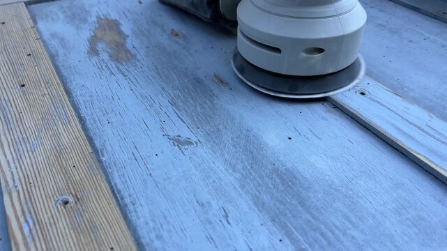 Close-up 4K shot of sanding wooden surface with power sander &ndash; woodworking renovation and DIY project footage