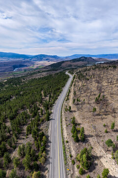Aerial View Of Scenic Winding Highway Through Mountain Landscape And Forests In British Columbia, Canada