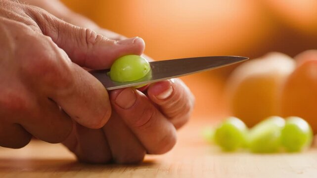 Spanish grapes, Chef cutting grapes with knife, preparing fruit salad or pie, fresh homemade dessert