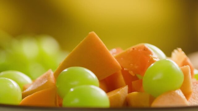 Chef cutting peach, apricot, nectarine and grapes with knife, preparing fruit salad for breakfast, homemade jam and juice