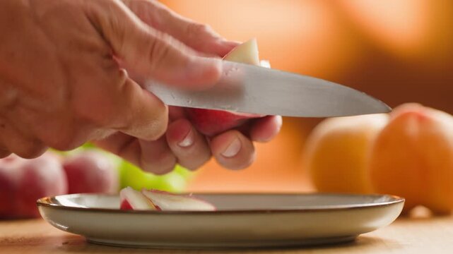 Chef cutting peach, apricot, nectarine and grapes with knife, preparing fruit salad for breakfast, homemade jam and juice