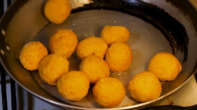 The cook places the chicken cheese balls from the package onto the frying pan