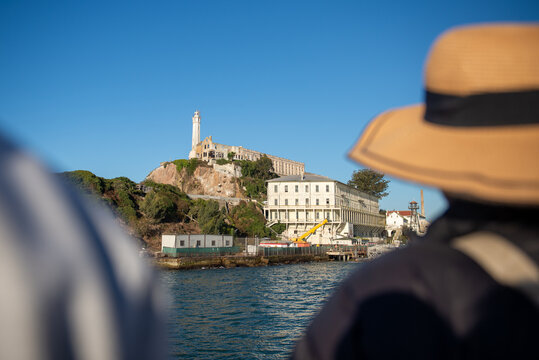 Visitors view Alcatraz Island from a boat in California waters during a clear day in the afternoon