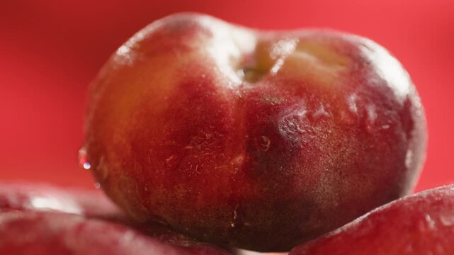 Nectarine or peach fruit, fresh Spanish red nectarine, peaches stacked on wooden table with red background
