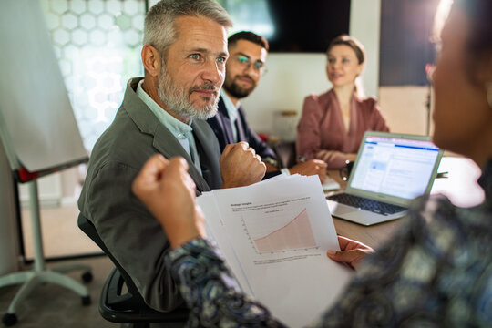 Business team discussing growth strategy in office meeting