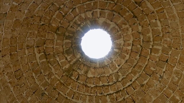 A round window in a brick structure with a skylight, suitable for interior design or architecture concepts