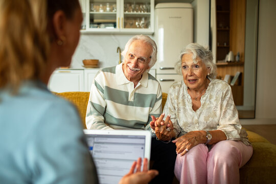 Senior couple meeting financial advisor at home