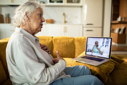 Senior woman having telehealth video call with doctor at home