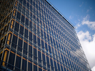 Fototapeta premium Modern Glass Office Building Against Blue Sky