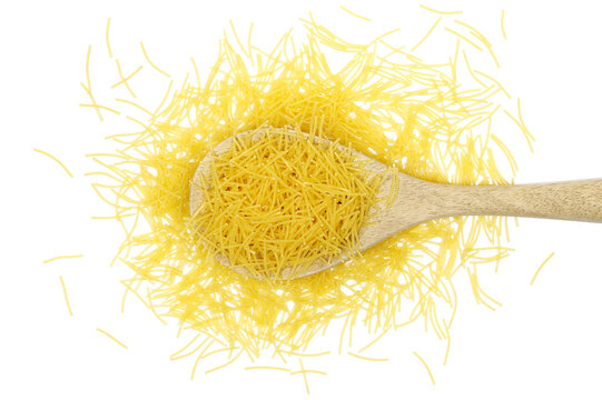 Uncooked durum wheat semolina pasta pile in wooden spoon isolated on white background, top view