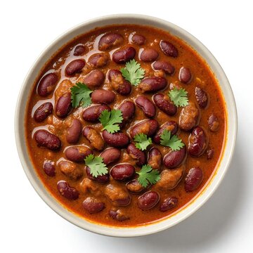 Top view of delicious rajma curry in white bowl. Red kidney beans cooked in spicy masala gravy garnished with fresh coriander leaves. Traditional Indian vegetarian meal served as healthy protein rich