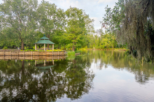 A gazebo along a pedestrian path surrounded by trees with Spanish Moss along the Waccamaw River at Riverfront Park, in Conway, South Carolina.