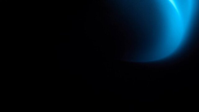 Cinematic blue lens flare on black background, anamorphic light leak overlay, soft glowing optical flare for video transitions
