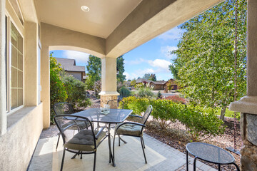 Fototapeta premium Outdoor Dining Setup, Patio With Scenic Garden View, Al Fresco Breakfast Or Evening Gathering Spot