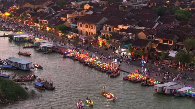Lantern Boats in of Hoi An city, Thu Bon River, Vietnam. Ancient town, UNESCO world heritage Site in Twilight, Aerial.