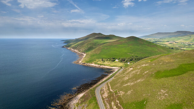 Drone aerial scenery Dingle peninsula Wild atlantic way winding coastal road oalong the rocky atlantic ocean coastline. Ireland, Irish landscape. Scenic route road trip. Slea head drive