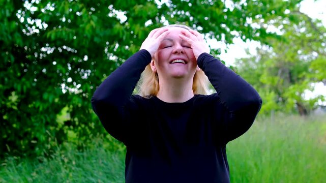 thoughtful gaze suddenly transforms into visible happiness as woman turns toward camera smiles warmly and adjusts her hair. The scene captures surprise relief optimism and positive emotional change.