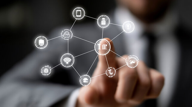Businessman pointing at a digital network interface with connected concept icons.