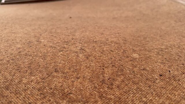 Brown coarse fabric texture with visible weave, closeup view. Natural linen material, burlap surface, rustic background, textile pattern
