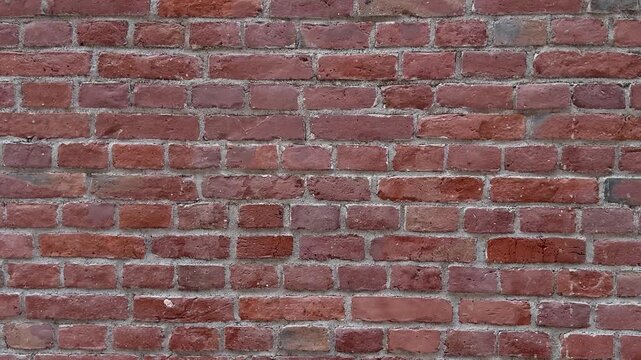 Red brick wall texture with light gray mortar joints, full frame. Old masonry surface, rustic backdrop, building material, retro pattern