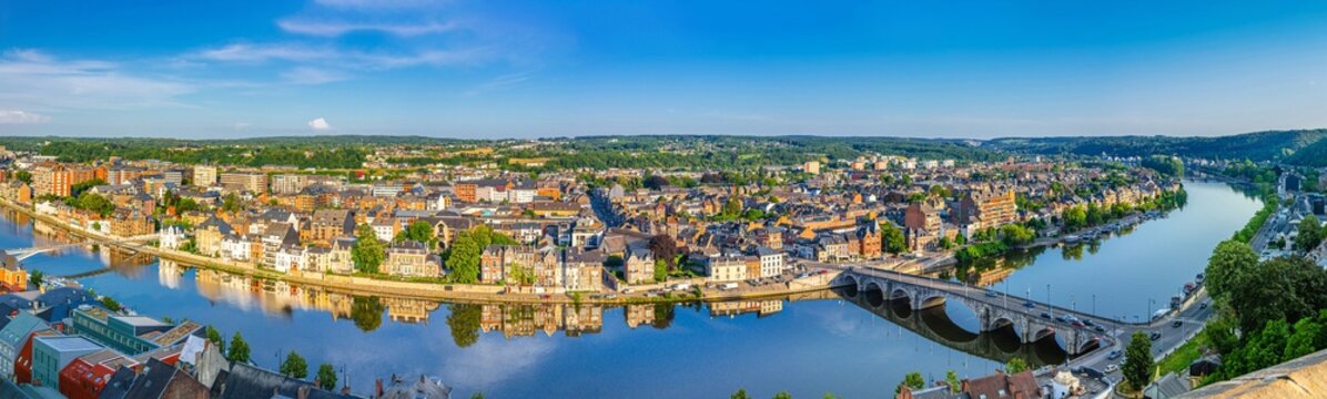 Panorama Namur city, aerial panoramic view of Namur cityscape, Meuse river embankment and Pont de Jambes bridge, Jambes district, forest hills skyline horizon with blue sky, Wallonia Region, Belgium