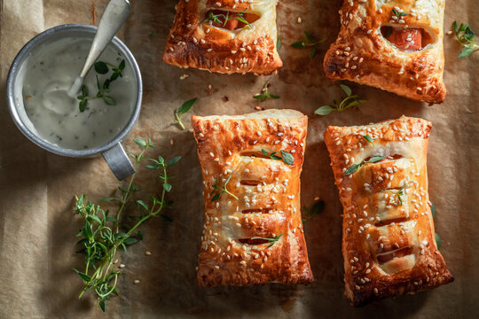 Tasty and unique sausage roll with tatar sauce and herbs.