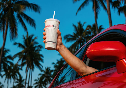 Arm Holding Takeaway Cup From Car Miami Style