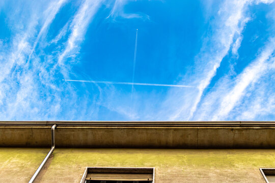 Crossing Contrails in Blue Sky Above Old Building, Italy, Lombardy, Mantua, 3 June 2026
