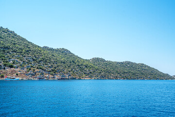 Fototapeta premium Turquoise waters and ancient Lycian coast of Kekova Island during a boat cruise in Antalya, Turkey.