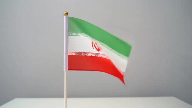 Small Iran Flag Waving on White Table Desk Stand Isolated on Grey Background
