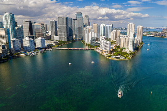 Miami skyline with skyscrapers along bay. Miami aerial cityscape with downtown buildings. Miami coastal skyline with blue sky. Miami urban district with modern towers.