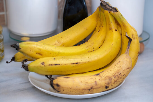 Fresh Ripe Yellow Bananas Bunch on a White Plate