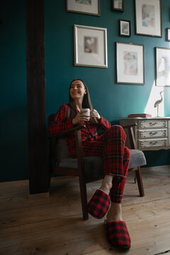 Woman in plaid pajamas relaxing with coffee at home