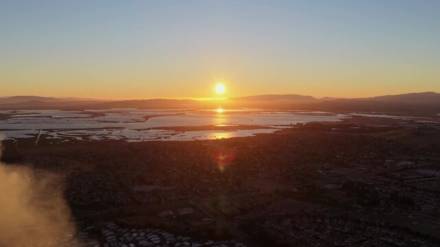 AMERICAN CANYON, CA - JULY 25, 2026: Static aerial vista at sunset over tidal wetlands and San Pablo Bay as haze from the Dutch Flat Fire hangs at the edge of town, California.