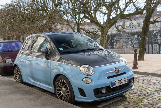 Nancy, France - March 22nd 2019 : View on a blue and grey Abarth 595 Turismo parked on a street with trees in the background.