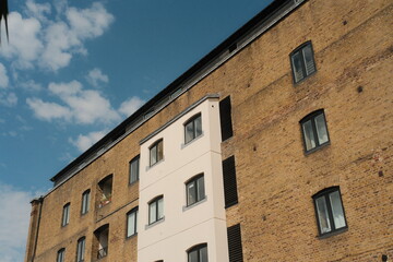 Fototapeta premium Modern white extension on traditional brick building