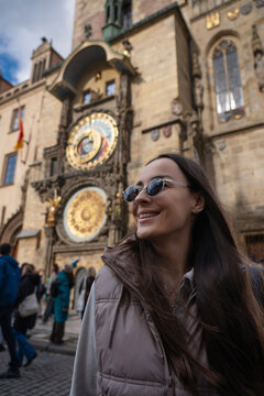 Smiling female tourist near Prague Astronomical Clock