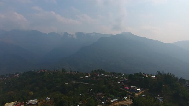 Aerial view drone shot of mountain village settlement and scenic landscape in Haflong, Dima Hasao, Assam, India. Stock footage.