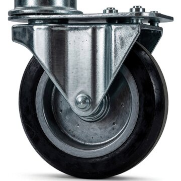 Heavy duty metal caster wheel with rubber tire attached to machinery or furniture. Swivel wheel offers mobility and smooth transport for heavy loads in industrial settings or workshops.