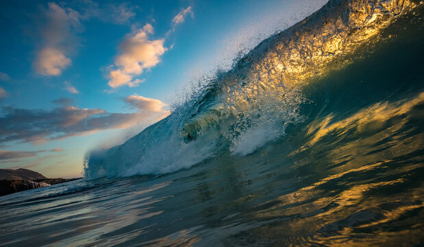 Dramatic Ocean Wave Cresting and Breaking in Golden Sunset Light