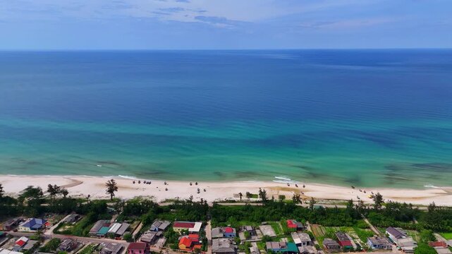 Aerial view of peaceful coastal fishing village with turquoise sea and white sand beach in Quang Tri Vietnam