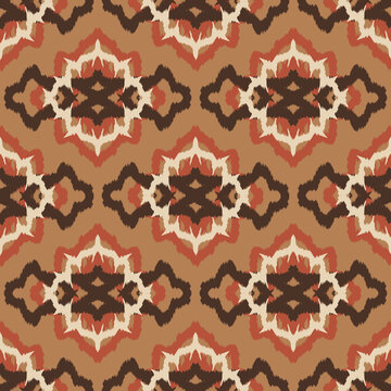 Seamless ethnic ikat pattern with earth tone beige ogee medallion ornament. Embroidered stitch texture design for bohemian fabric, textile, apparel, wallpaper, and background.