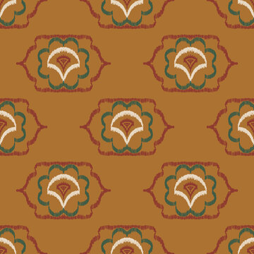 Seamless ethnic ikat pattern with ochre yellow floral ogee medallion ornament. Embroidered stitch texture design for bohemian fabric, textile, apparel, wallpaper, and background.