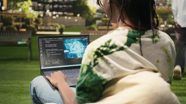 The student uses binary code and artificial intelligence on a laptop, programming language with machine learning and neural networks, during solo study on a modern campus, reflecting student life.